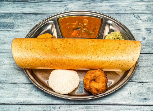 masala dosa thali set with sabji and chutney served in dish isolated on wooden table top view of indian spicy food