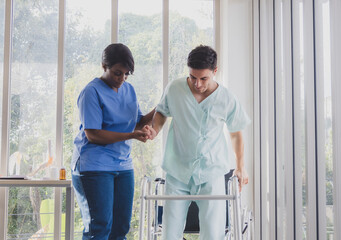 Portrait patient caucasian man with woman nurse carer physical therapist African-American two...