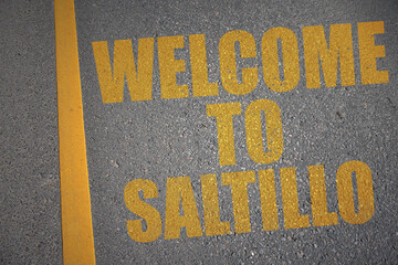 asphalt road with text welcome to Saltillo near yellow line.