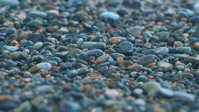 Sea Travel. Sea Foam Surf And Shiny Multi-Colored Pebbles. Background Of Sea Water.