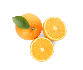 Cut and whole fresh ripe oranges with green leaf on white background, top view