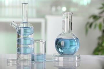 Laboratory analysis. Different glassware with liquid on white table indoors