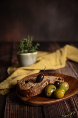 Bowl with different olives on dark wooden background 