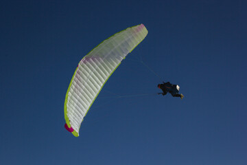 Paraglider flying. Blue sky. 