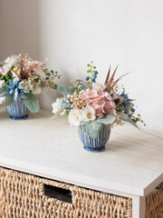 Colorful flower decoration in blue vase. Decorative flower