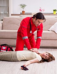 Young male paramedic visiting young woman