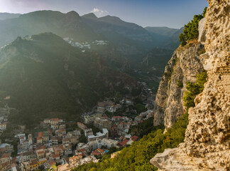 Typical Italian small town in the valley between the rocks shot from the high angle in the mountains on sunset