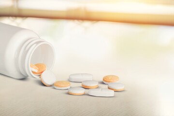 Colored antibiotic pills in plastic drug bottles.