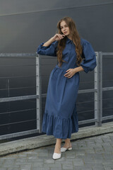 female in blue summer dress outdoors