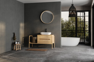 Modern bathroom interior with dark walls, ceramic basin with mirror, bathtub and grey concrete floor. Minimalist black bathroom with modern furniture and big windows, yard.