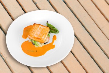 Fried tasty fish dish with vegetable served on plate