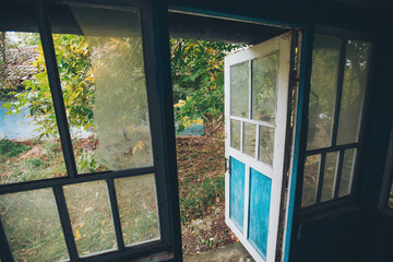 Old abandoned room and light from a window. Old ruined house. interior of an abandoned house. garbage in abandoned room with windows. Peeling walls, trash on the floor. Room of destroyed house