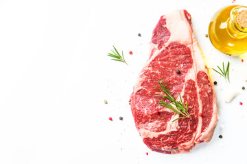 Meat steak. Beef steak ribeye with spices and herbs on white background. Top view with copy space.
