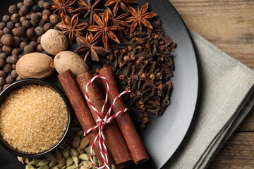 Dishware with different spices on table, top view