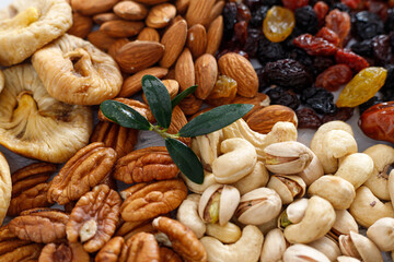 Mixed nuts and dried fruits on a light concrete background. Symbols of Tu Bishva