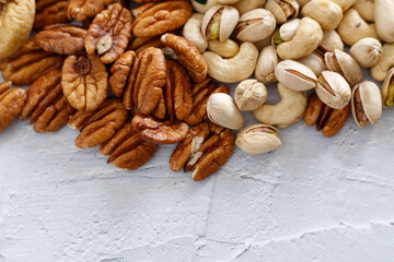 Mixed nuts and dried fruits on a light concrete background. Symbols of Tu Bishva