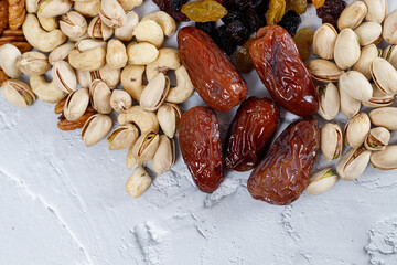 Mixed nuts and dried fruits on a light concrete background. Symbols of Tu Bishva