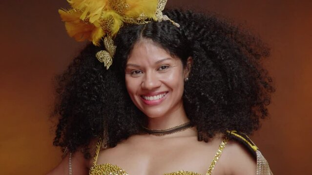 beautiful black Brazilian woman, in golden carnival clothes. close-up scene