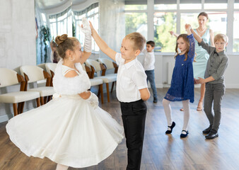 Children dance in pairs at a festive matinee