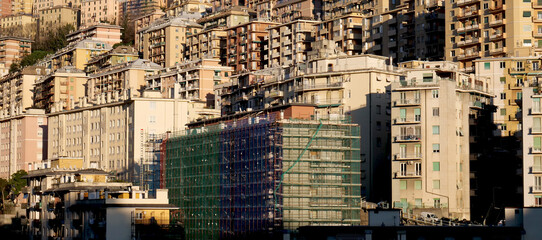 Houses in a residential neighborhood in Italy with scaffolding on a building