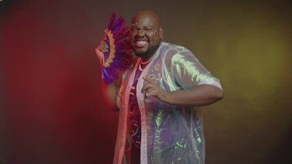black Brazilian man. in carnival clothes, dancing with a fan.