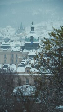 landscape in winter in Prague, Czech Republic with Straka Academy dome in the evening.