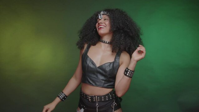 Black Brazilian woman, in black carnival clothes, dancing and partying.