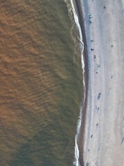 Aerial shot of Budleigh Salterton beach in East Devon, England with gentle waves lapping the pebble...
