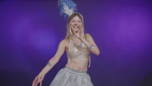 White Brazilian woman, wearing silver and blue carnival clothes, welcome, dancing.