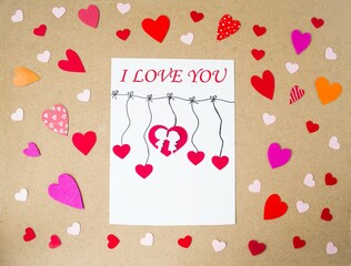 Handmade holiday card for Valentine's Day, red hearts, love theme.  Flat lay, top view.  Valentine's Day holiday concept.
