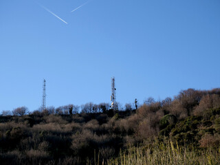 Mobile communications antennas and radio repeaters on the hills - 715984474