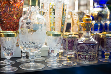 Variety of glassware and souvenirs from famous Bohemian crystal on showcase of boutique.. - obrazy, fototapety, plakaty