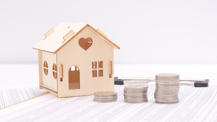 Small houses, coins and office supplies on financial statements