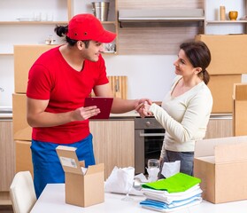 Young male contractor and female customer in moving concept