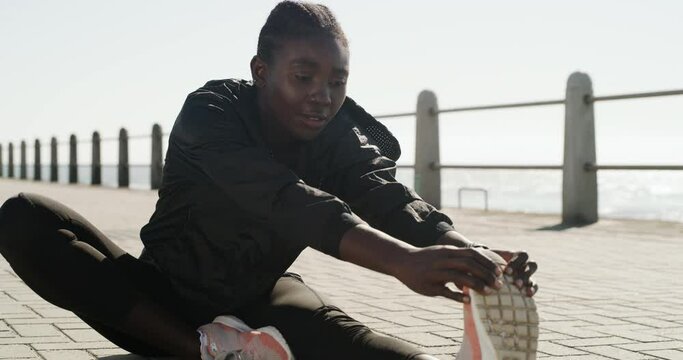 Fitness, beach or black woman stretching legs in summer to start training, exercise and cardio workout. African runner, thinking and sports athlete with running shoes in warm up for hamstring muscle