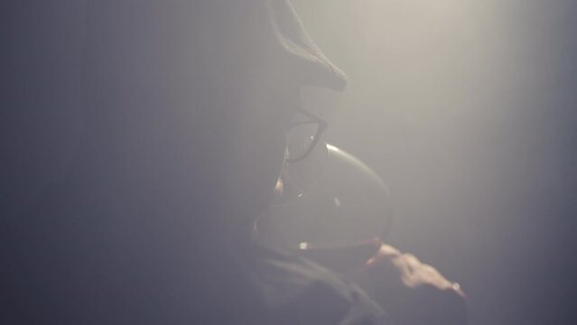 Man somellier sniffing red wine in a glass, slow motion cinematic shot