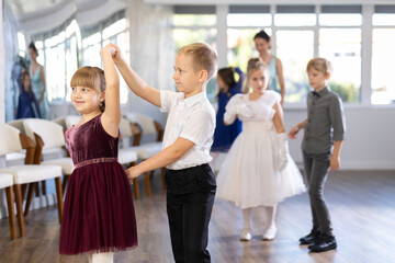 Fototapeta na wymiar Classical dances performed by preteen children in beautiful festive clothes