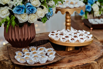 wooden table decorated with sweets and flowers
