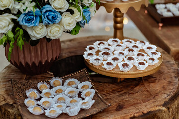 wooden table decorated with sweets and flowers