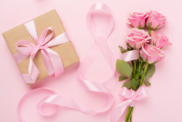 Composition with pink roses, gift box and eight made of ribbon on color background, top view. Women's day concept