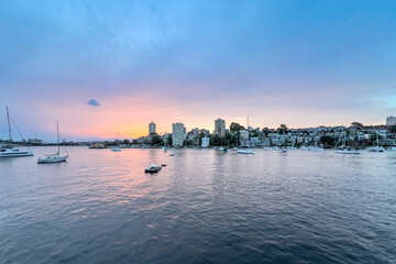 Sydney Harbour viewed from North Sydney at Sunset with Sydney City Skyline and CBD high-rise,  colourful skies NSW Australia