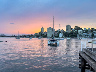 Sydney Harbour viewed from North Sydney at Sunset with Sydney City Skyline and CBD high-rise, ...