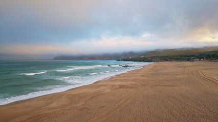 Gloomy sea surf evening nature in slow motion. Sunset with low hanging clouds