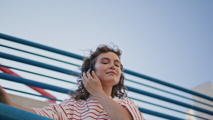 Headphone woman moving tact rhythmic music at street close up. Girl listening