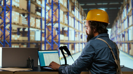 Export manager creating invoice with barcode scanner at pc, billing shipment and client details for delivery. Warehouse administrator checking stock of merchandise, examining labels on pallets.
