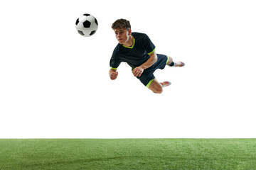 Obraz premium Dynamic image of young man, football player in motion, hitting ball with head isolated over white background with grass flooring. Concept of sport, game, competition, championship, active lifestyle