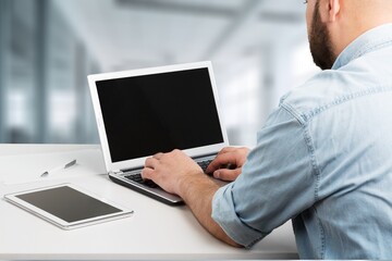 student  or worker looking at laptop with a blank screen