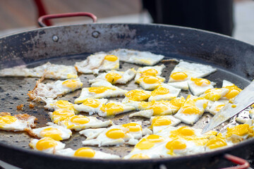 Blurred image of fried eggs at a street food festival.
