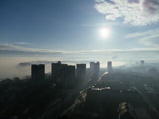 Drone aerial view of Belgrade city in the smog and fog in the morning. Zemun and New Belgrade district, Serbia, Europe.
