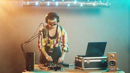 Woman DJ sends air kisses from club stage, sending love to her fans after mixing amazing techno...